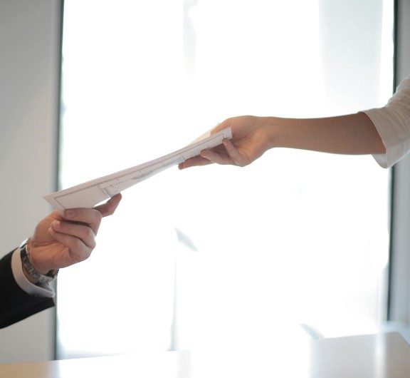 A document being handed off between advisor and client
