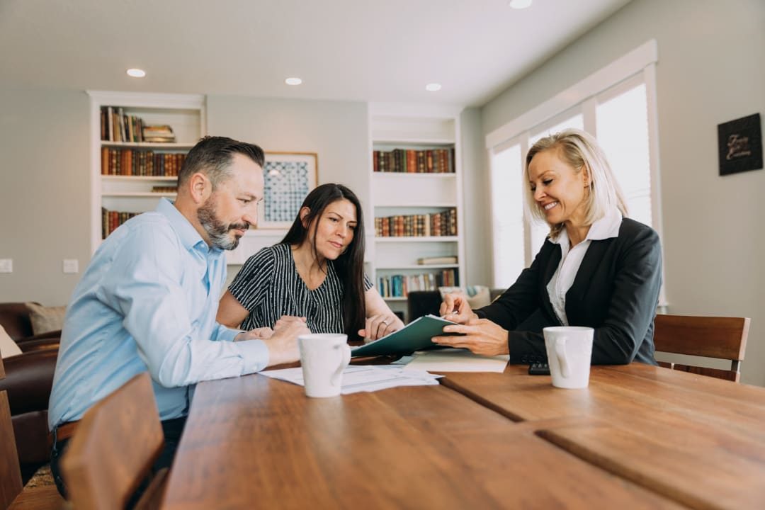 An advisor reviewing tax documents with clients at a table